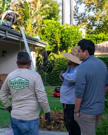 Preferred Roofing estimator talking with a homeowner