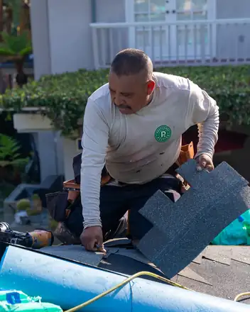 Crew member installing new shingles