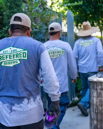 Crew arriving at a job in Preferred Roofing shirts